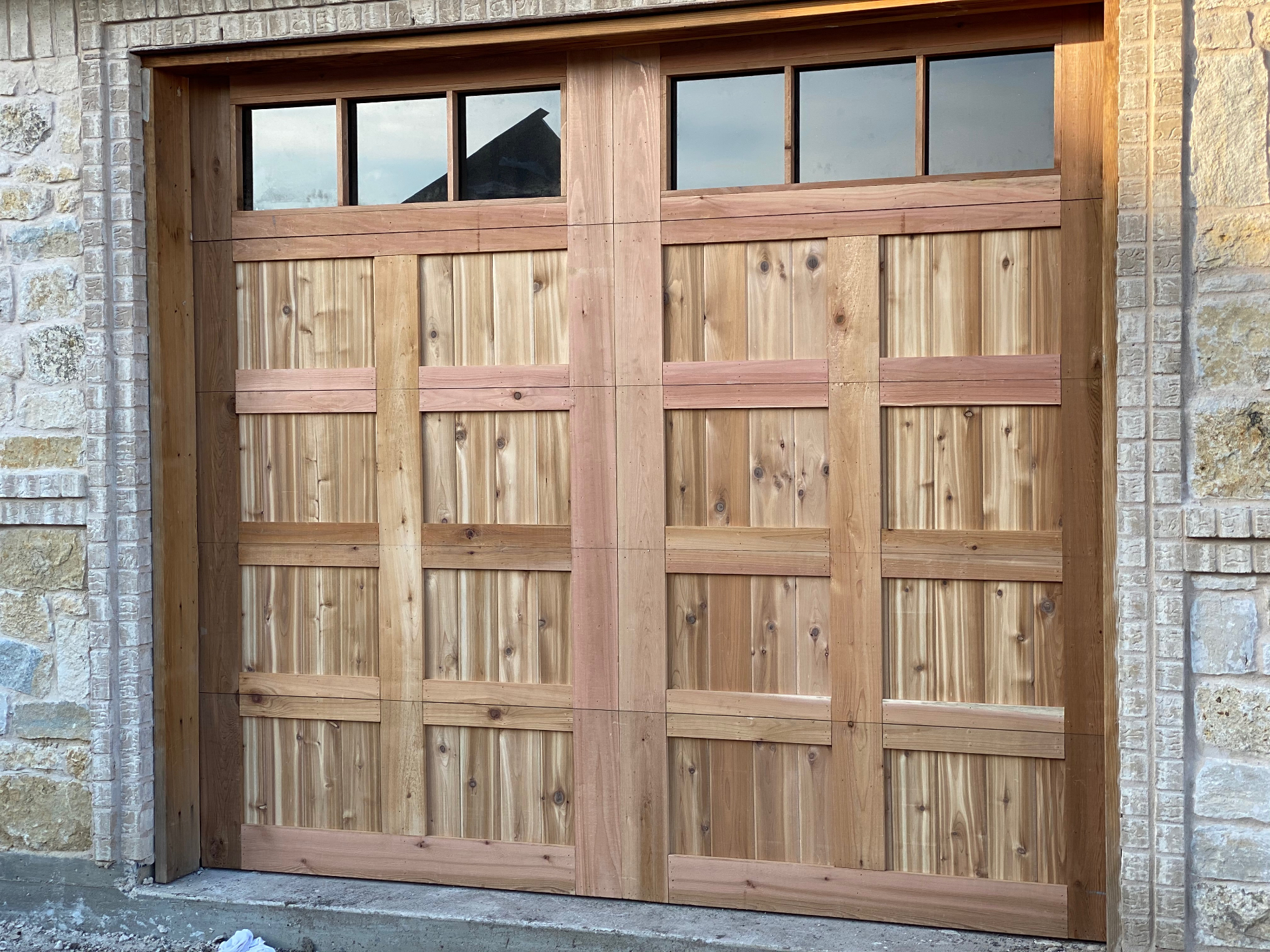 Custom cedar wood garage door with window panels